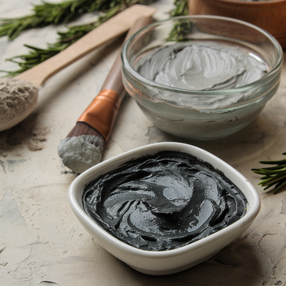 bowls of body masks and brushes used to apply body masks